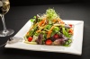 House Salad - Mixed greens, grape tomatoes, carrots, cucumber, onion sprouts and house dressing.
