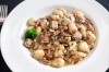 Gnocchi con Funghi - Potato gnocchi gently cooked with cremini mushrooms and a rich gorgonzola cream sauce.